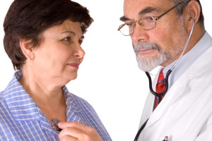 An elderly women being examined by a doctor